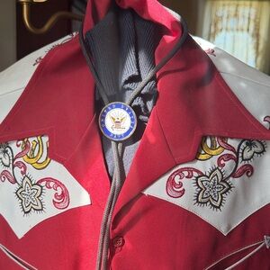 Bolo tie featuring a Navy medallion coin,